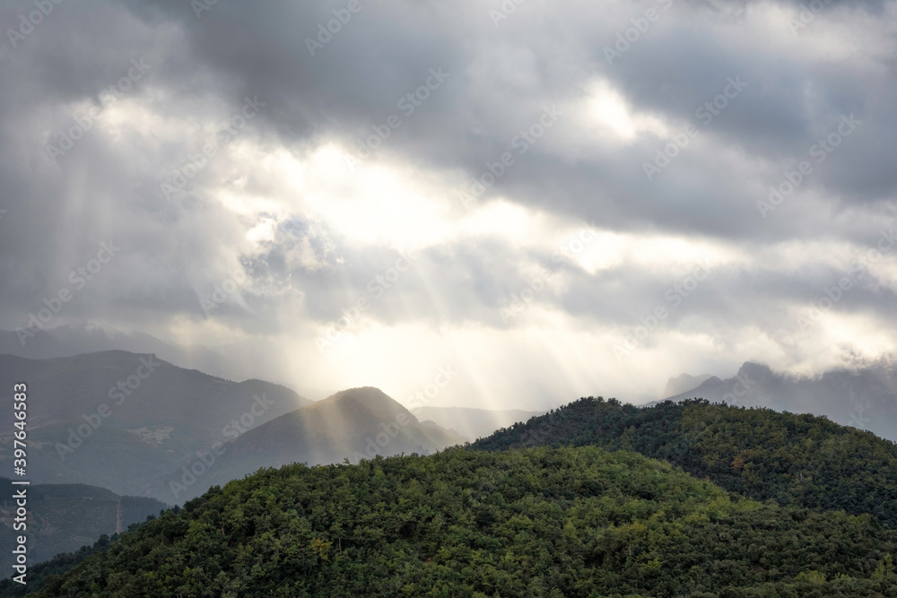 green mountains landscape with gray clouds, dramatic sky