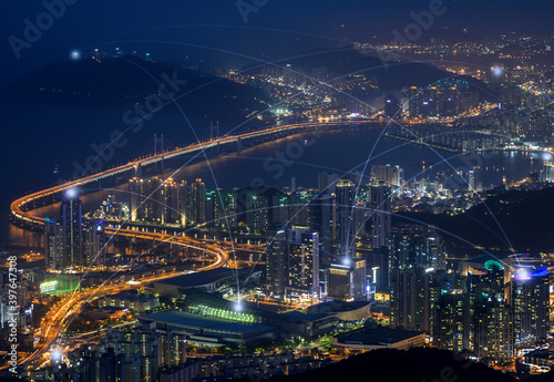 Smart city and connection lines. Cityscape of Busan, South Korea, at night. Technology, network connection, information and smart city concept.