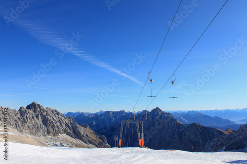 Top of Germany: Panorama view on a sunny day from the glacier ski area Zugspitze, the highest German mountain to the mountains, peaks and ridges of the german, Austrian, Italian, Swiss alps