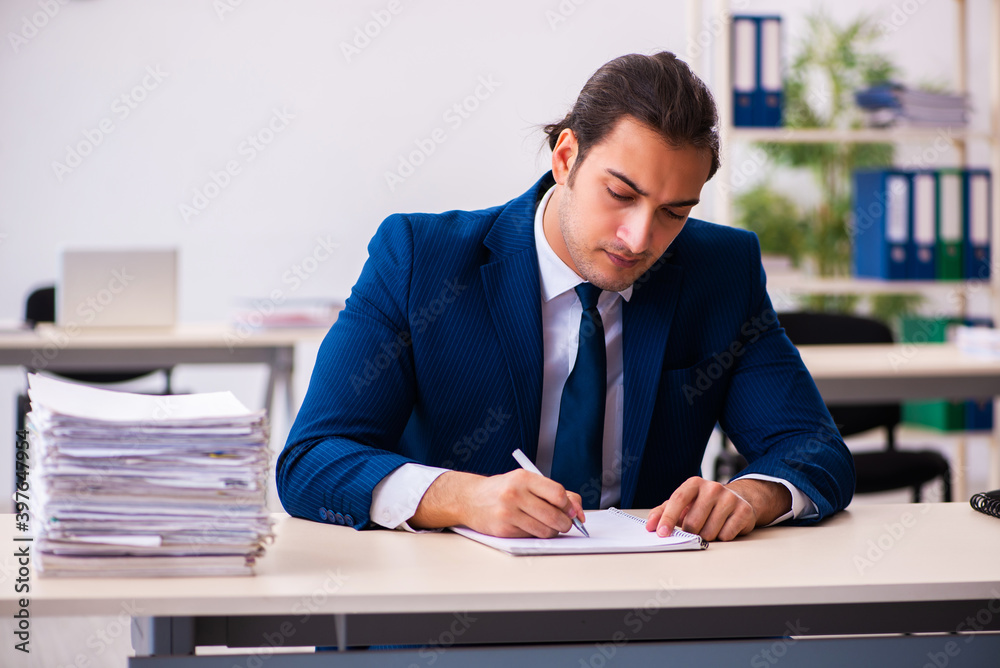Young male employee working in the office Young male employee working in the office