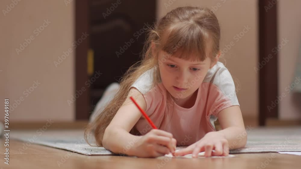 Little girl draws 7 years old caucasian white closeup Little girl draws 7 years old caucasian white closeup