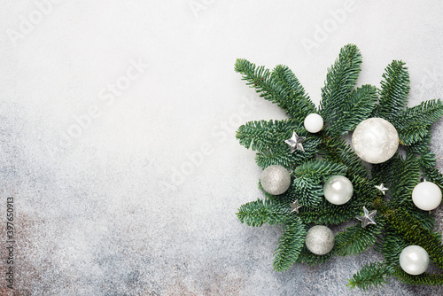 Branch of Christmas tree deocrated with silver colored toys. Christmas, New Year background photo