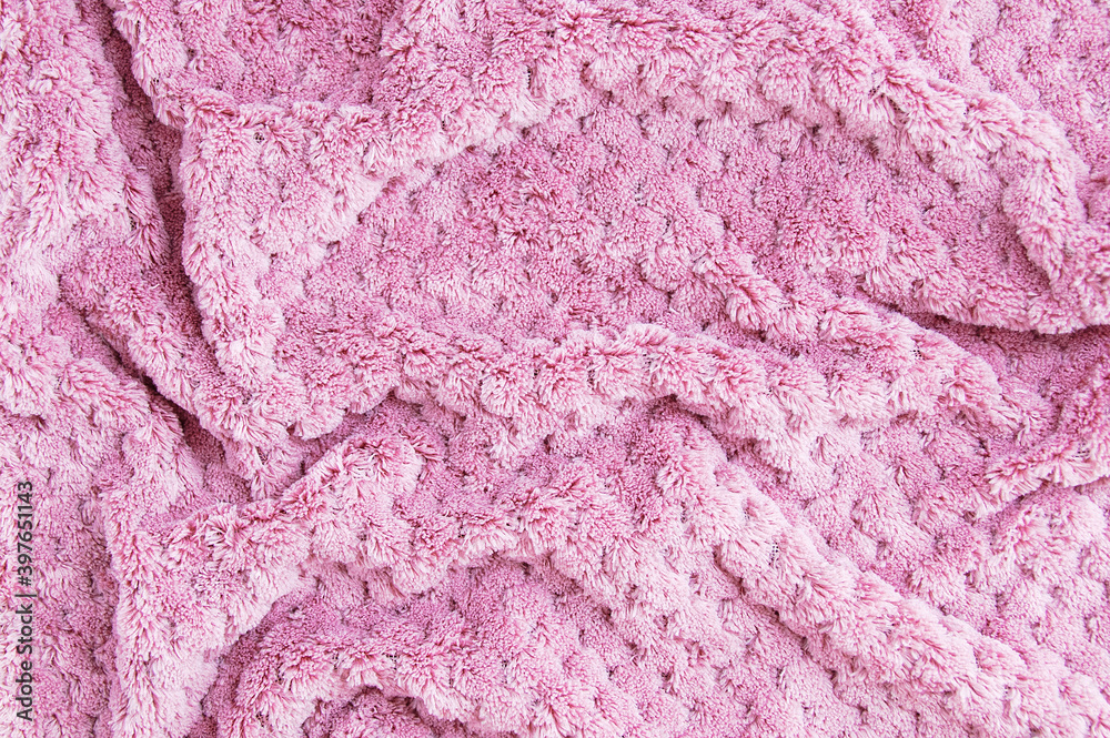 The texture of fluffy pink plaid close-up. The texture of fluffy pink plaid close-up.