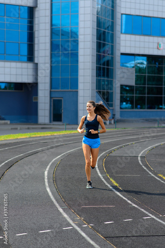 Athlete runner running on athletic track training her cardio.