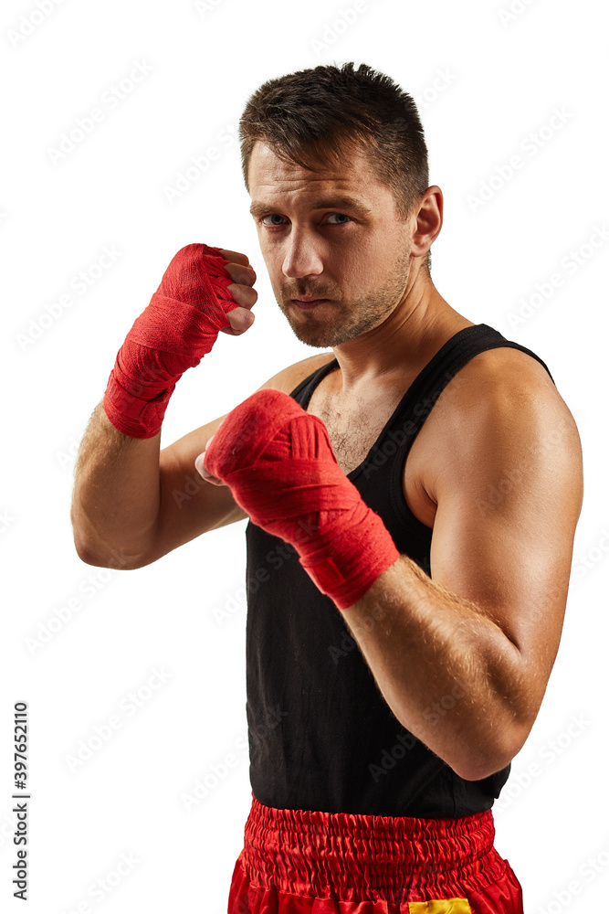 Handsome sporty man in red sports bandages on his hands fighting isolated on white background