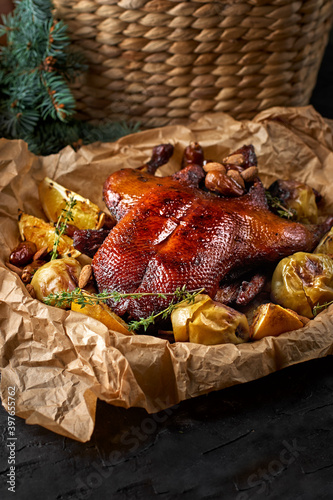 Baked duck stuffed with oranges and rosmarina. Festive table. Black background. Space for text