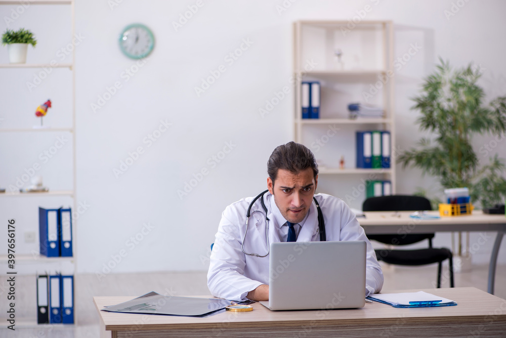 Young male doctor in telemedicine concept Young male doctor in telemedicine concept