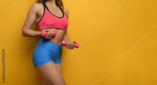Girl trains with handlebars. yellow color background