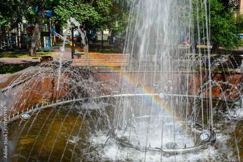 Rainbow in the streams of the fountain, square in front of house 54 on Shcherbakovskaya street, Moscow, Russian Federation, August 22, 2020 photo