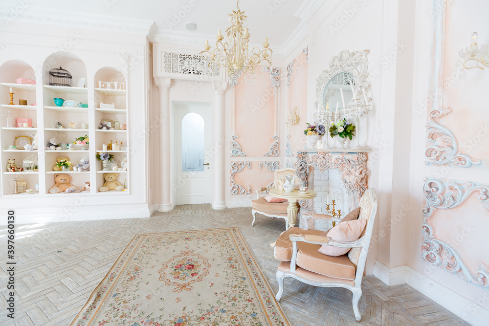 Luxurious expensive interior design of the children's room in the old Baroque style in beige colors