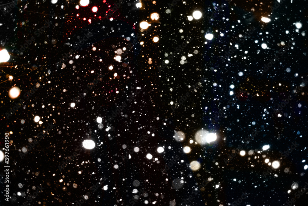 Falling snow flakes on black background, useful for overlays