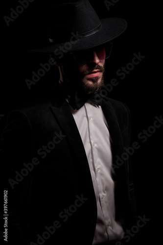 young fashion businessman in black velvet tux looking to side