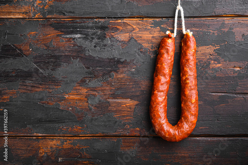 Traditional spanish chorizo sausage on wooden surface with space for text photo