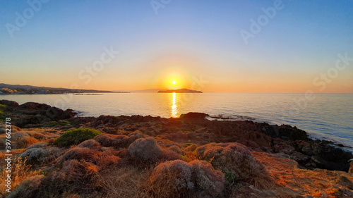 Colorful sunset over the water on Crete, Greece. © abrada