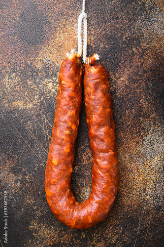 Spanish chorizo salami sausage on old metall background