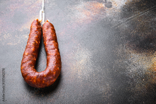 Traditional chorizo salami sausage on old metall background with space for text