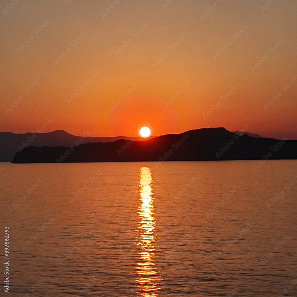 Colorful sunset over the water on Crete, Greece.