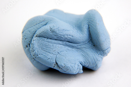 Blu Tack with visible grainy texture. Photo with selective focus. Macro photo