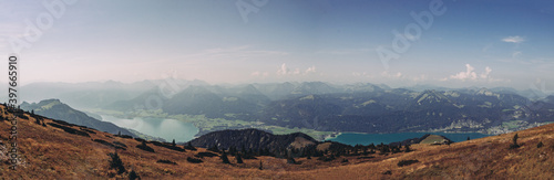 panorama of the entire Wolfgangsee lake overlooking the surrounding alps in daylight. A beautiful hike to a magical place near Salzburg. Shore are Strobl, St. Gilgen with the villages of Abersee photo