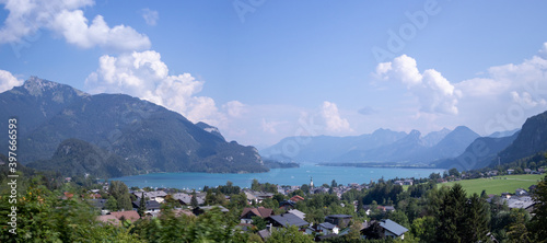 Panorama Wolfgangsee the largest lake in Austria along with the towering mountains around it. Fancy view from the town of Sankt Gilgen to the whole body of water photo