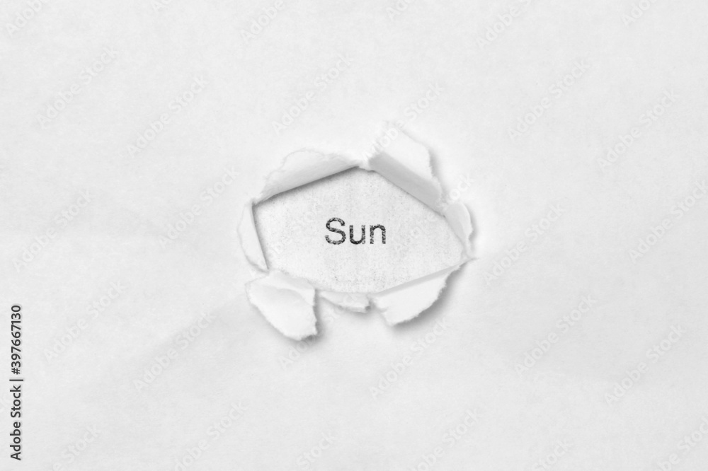 Word sun on white isolated background through the wound hole in the paper. Word sun on white isolated background through the wound hole in the paper.
