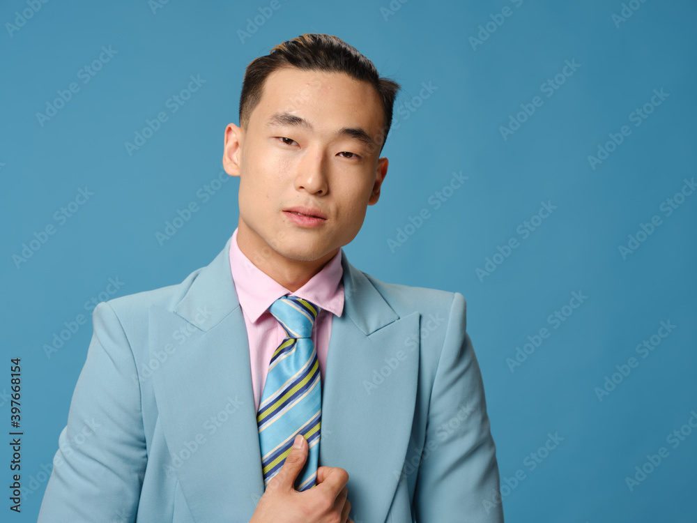 Business man in jacket and tie blue background cropped view Business man in jacket and tie blue background cropped view
