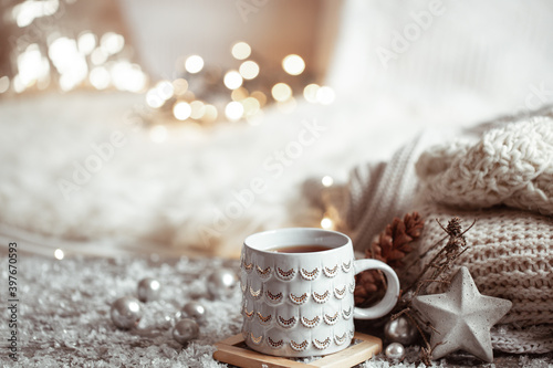 Cozy winter background with a beautiful cup, decor details and bokeh copy space.
