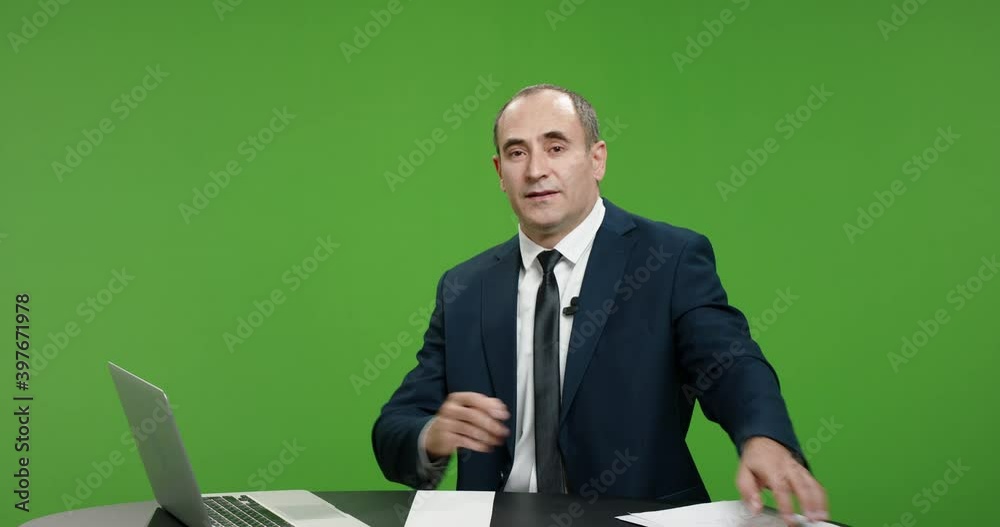 Positive male newsanchor reporting on current events. Happy man wearing a suit telling good news, shot on green chroma key background 4k footage Positive male newsanchor reporting on current events. Happy man wearing a suit telling good news, shot on green chroma key background 4k footage