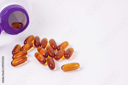 Omega 3 fish oil or lecithin capsules.Pile of brown softgel pills closeup on white background.Healthy nutrition and lifestyle concept. Nutraceuticals with omega3 polyunsaturated fatty acids.