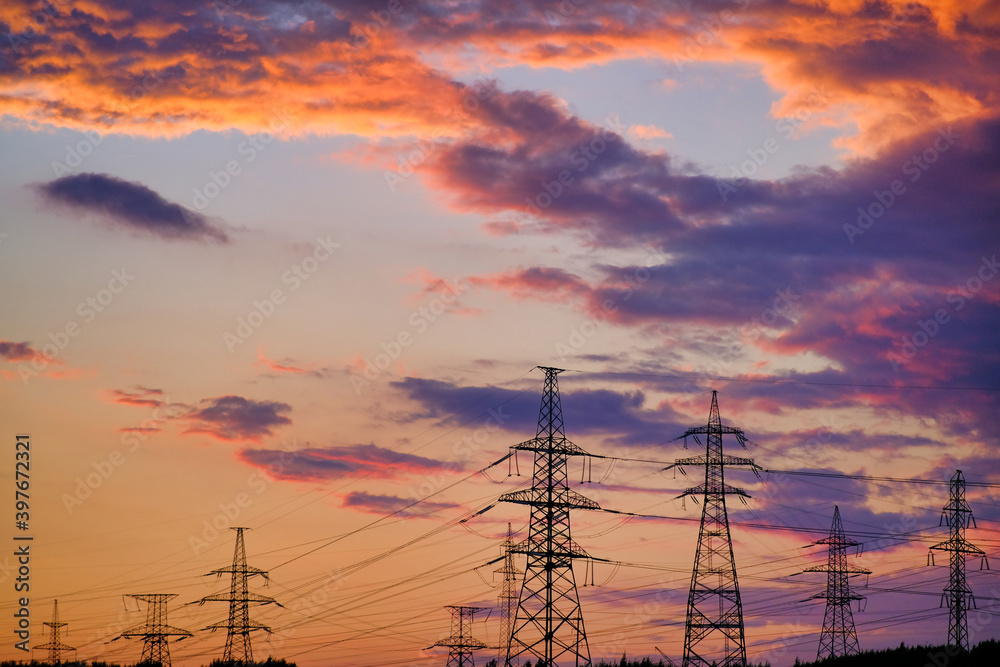 Towers with insulators on which the wires are fixed. High-voltage power transmission line. An extended structure of wires, cables and supports for the redistribution of electricity in the city. Towers with insulators on which the wires are fixed. High-voltage power transmission line. An extended structure of wires, cables and supports for the redistribution of electricity in the city.