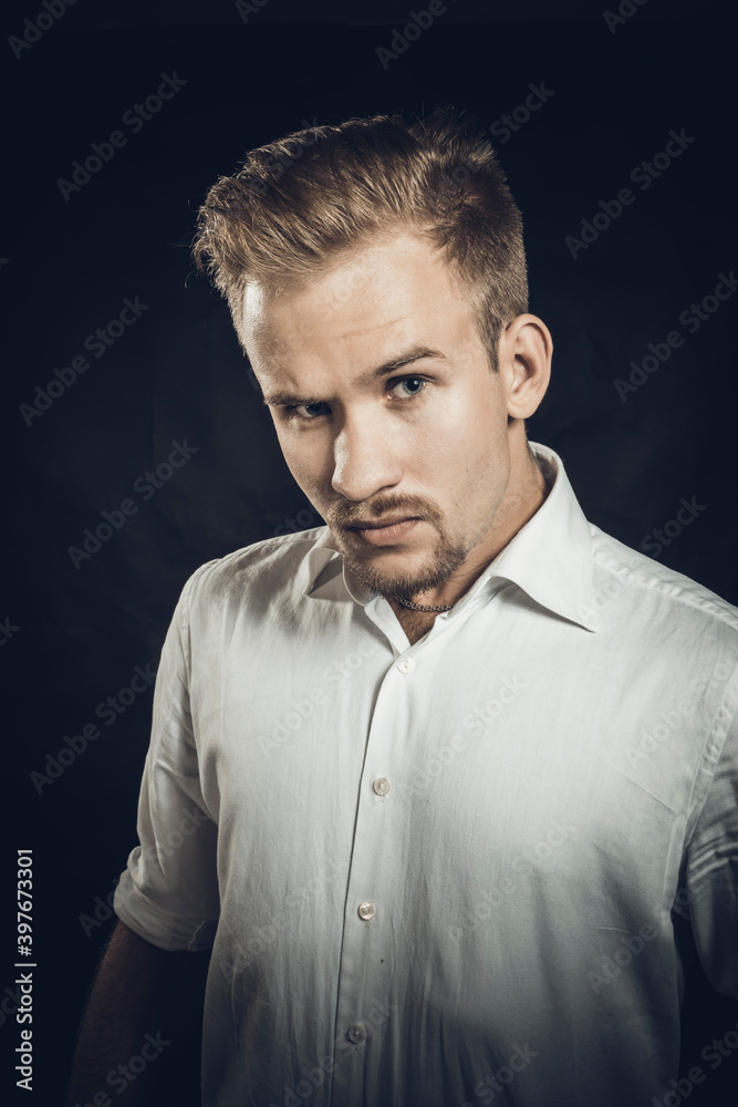 Fototapeta premium Young man dressed in white shirt studio portrait