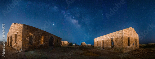 Old village ruins under Milky Way