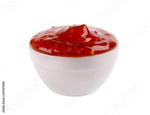 Sweet chili pepper sauce in bowl, isolated on white background. Spicy tomato and chili pepper sauce.