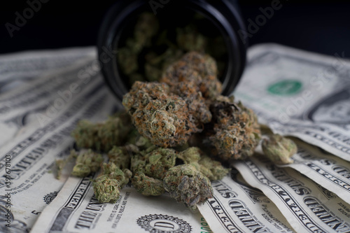 marijuana spilling on money stock market investment concept