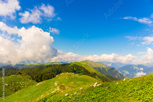 Beautiful mountain landscape at Caucasus mountains with clouds and blue sky © idea_studio