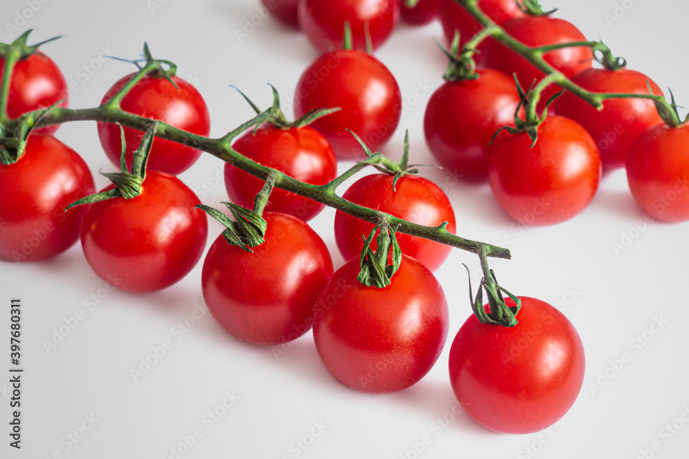 Two sprigs of small red cherry tomatoes Two sprigs of small red cherry tomatoes