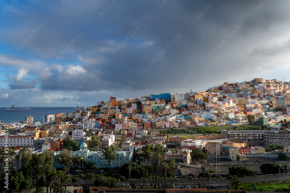 Las Palmas de Gran Canaria cityscape at sunset.  El Risco de San Juan colorful houses