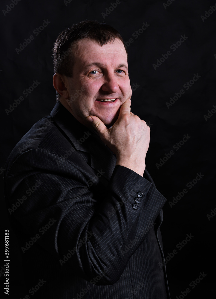 Middle aged solid man dressed in suit studio portrait