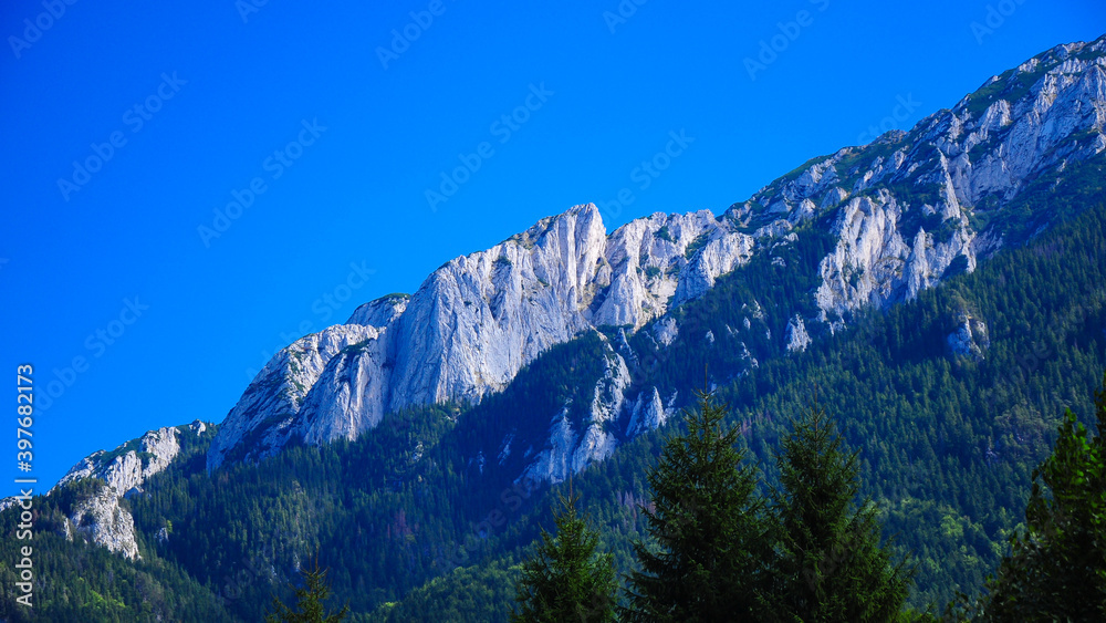 Piatra Craiului Mountains with their steep abysses in a clear summer day. Carpathia , Romania