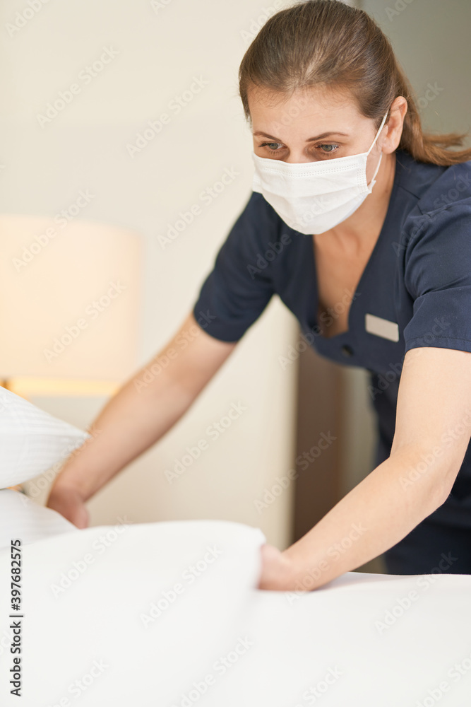 Experienced young maid cleaning a luxury hotel room Experienced young maid cleaning a luxury hotel room