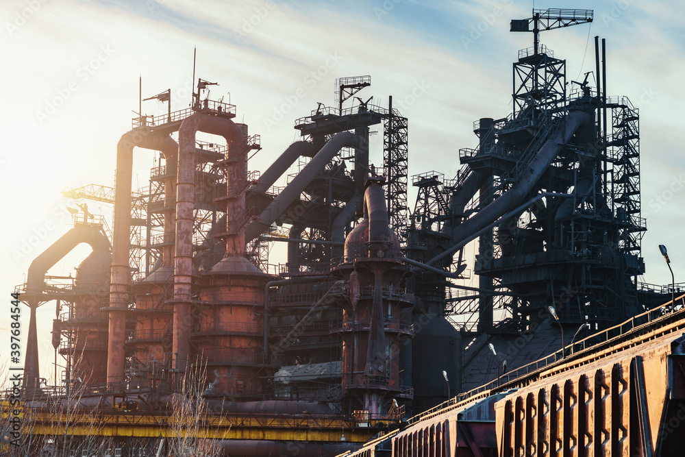 Blast furnace of metallurgical plant or chemical factory, large steel industrial buildings and pipelines. Blast furnace of metallurgical plant or chemical factory, large steel industrial buildings and pipelines.