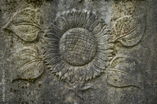 sun flower fresco on a weathered tombstone
