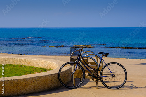 An isolated bicycle parked by the sea