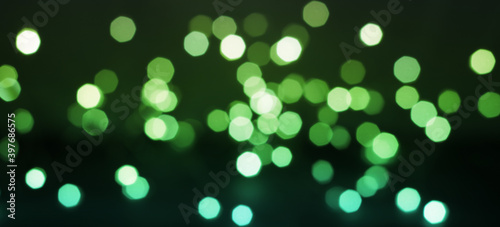 Panoramic photo of bokeh of blue-green lights