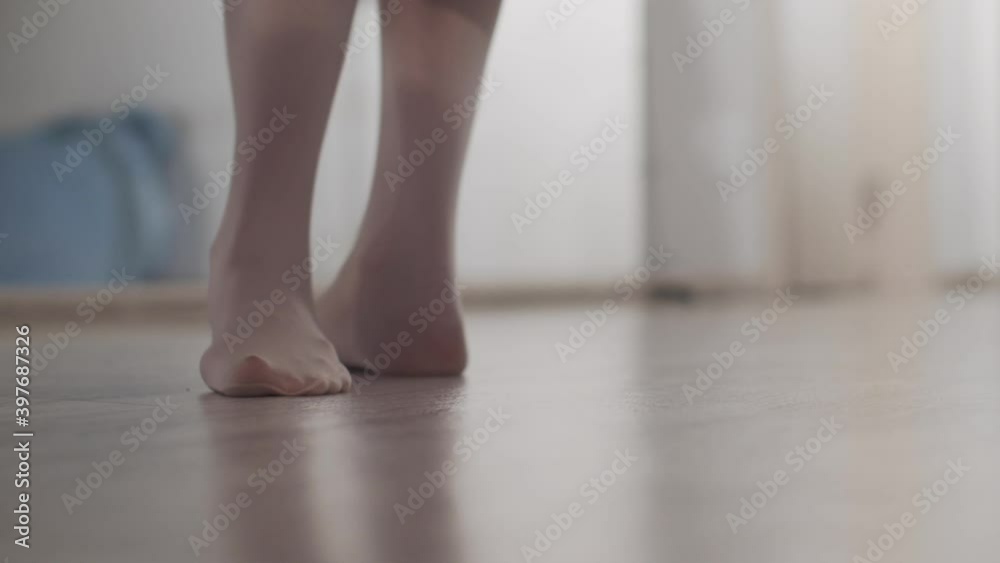 Feet of a girl dancer close-up at the warm-up before the performance, she kneads the muscles and joints Feet of a girl dancer close-up at the warm-up before the performance, she kneads the muscles and joints