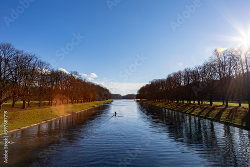view on a lake with reflections of trees in the water, rowing boat on the lake © Stockhausen