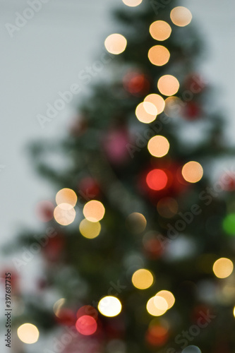Blurred image of Christmas tree with flashing lights. bottom