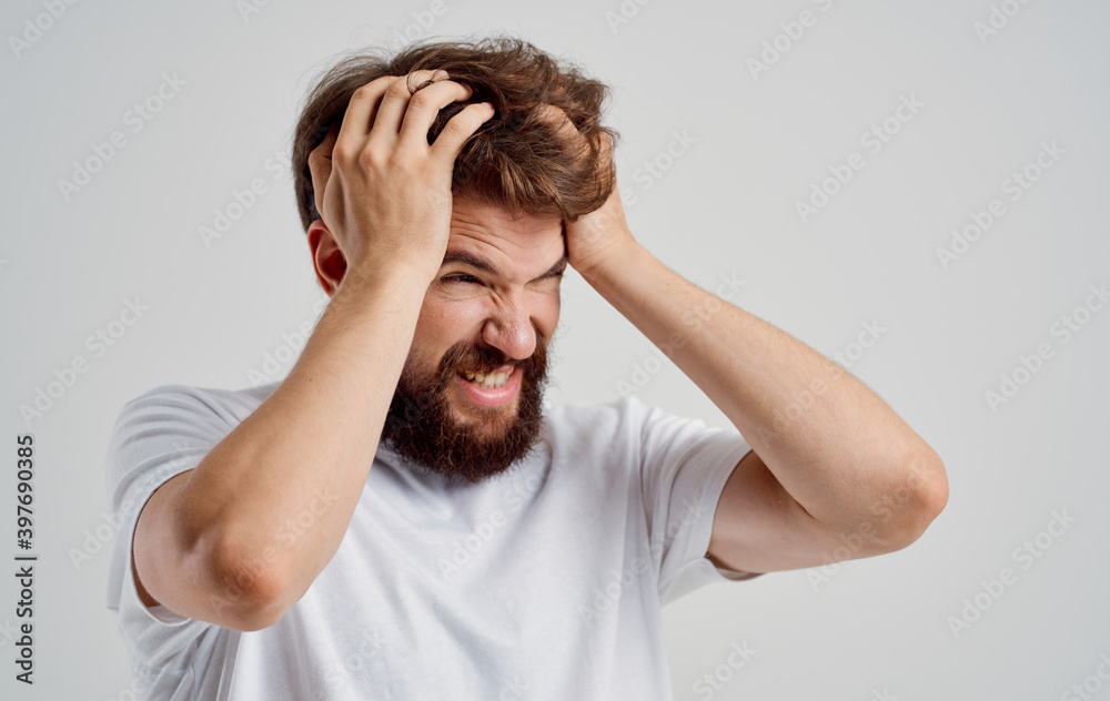 bearded man holding his head discontent health problem disorder bearded man holding his head discontent health problem disorder