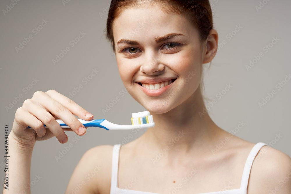woman holding a toothbrush with paste in her hands dental care hygiene close-up woman holding a toothbrush with paste in her hands dental care hygiene close-up