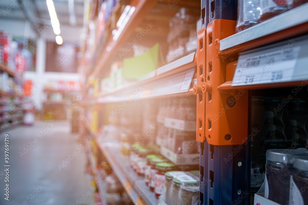 Naklejka premium Wholesales or supermarket blurred shelves with different products
